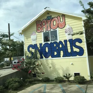 a building with a sign that says bayou snowballs