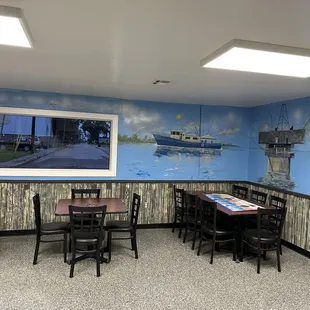 a man standing in front of a painting of a boat