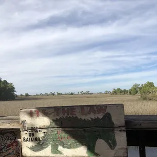 Warning sign on deck overlooking the marsh - 12/2021