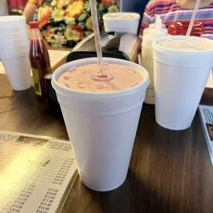 two people sitting at a table with drinks