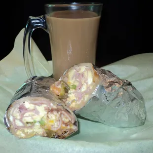 Lovely Breakfast Burrito with egg, cheese, beans, sour cream, ham, house recipe secret salsa and other yummy ingrediants