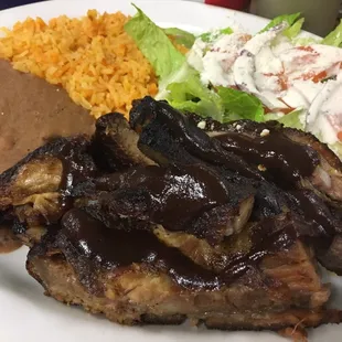 Ribs, refried beans, rice, and salad (blue cheese/ranch?) hella good