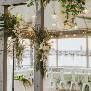 a view of a wedding venue with flowers and greenery