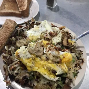 Before I mangled it, it is Italian skillet with eggs over medium with wheat toast.