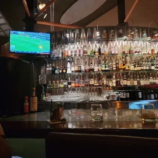 a bar with many bottles of alcohol