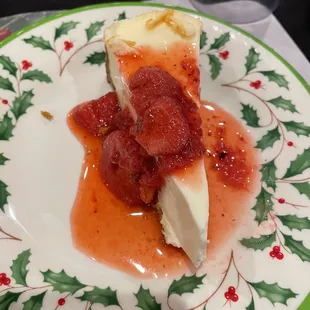 a slice of cheesecake with strawberry sauce
