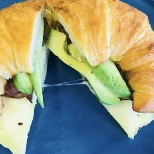 a croissant sandwich on a blue plate