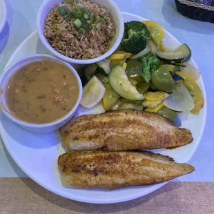 a plate of fish, rice and vegetables