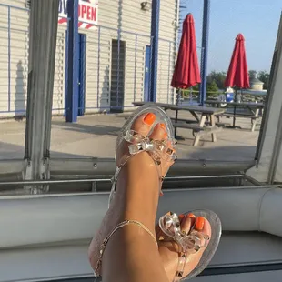 a woman's feet in clear sandals