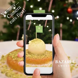 a person taking a picture of a dessert