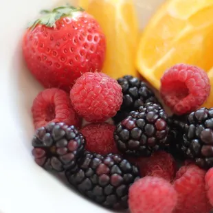 a bowl of berries and lemons