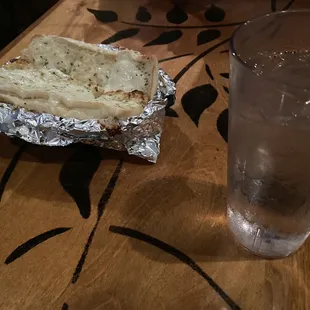a glass of water and a piece of bread