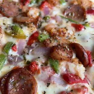 Tchoupitoulas Pizza. cajun shrimp, house roasted red pepper, green pepper, red onion, andouille sausage, fresh garlic