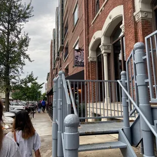 a woman walking down the sidewalk
