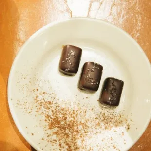 three pieces of chocolate on a plate