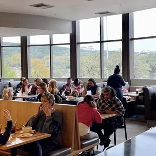 a large group of people sitting at tables in a restaurant