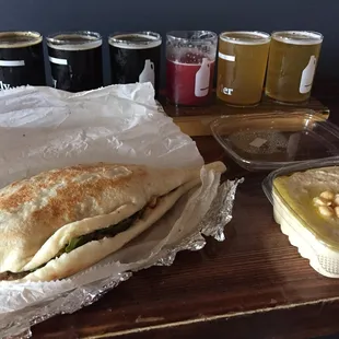 a sandwich with a side of dips