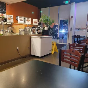 Inside with their cold item/salad food prep and ordering counter/cashier. There&apos;s about 6 or so tables (seats 4 each) along the wall.