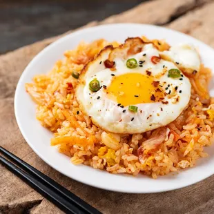  a fried egg on top of rice