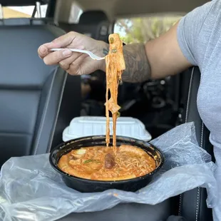 When you live in your car: Enjoying this cheesy-creamy Ddeok Bokki meal while waiting to pick up my daughter from school.