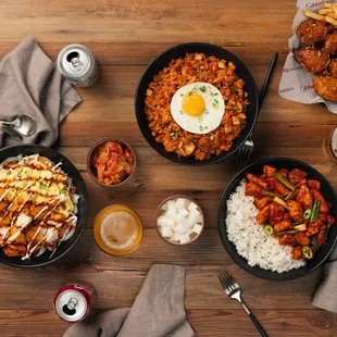 three bowls of food on a wooden table