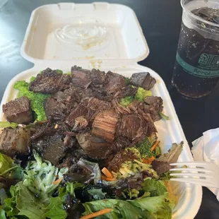 Brisket with salad, and broccoli.