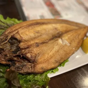 grilled fish on a bed of lettuce