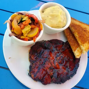 a grilled steak with a side of mashed potatoes