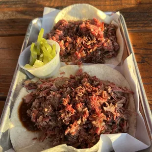 Brisket Breakfast Tacos with an over easy egg hiding under the meat