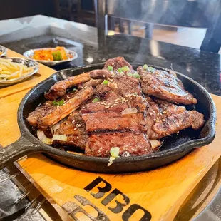 Galbi / Kalbi   - wonderful char, grilled to medium rare, and a perfect pairing for their tasty and plentiful naengmyun.