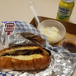 Beef brisket sandwich with potato salad, bbq sauce on the side and a lemonade all part of the combo!