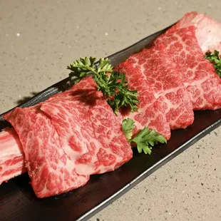 raw beef on a black plate