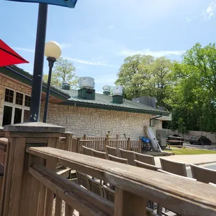 a view of a patio with tables and umbrellas