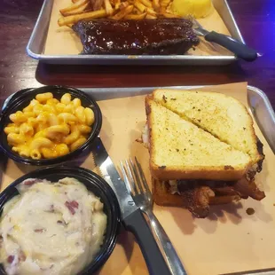 Big Texan Burger with smoked gouda Mac and cheese and mashed potatoes.  Half rack of ribs and fries and cornbread