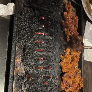 a large grill with meat on it