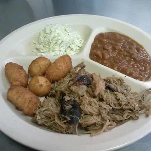 pulled pork, beans, potatoes, and coleslaw