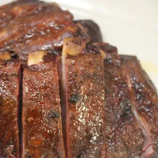 a close up of ribs on a plate