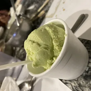 a cup of green ice cream