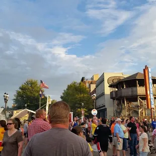 a crowd of people standing in the street