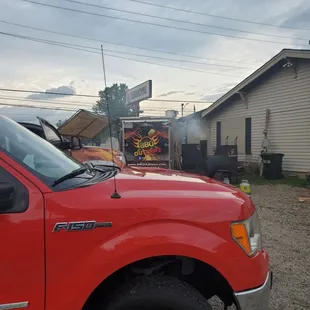 a red truck parked in a lot