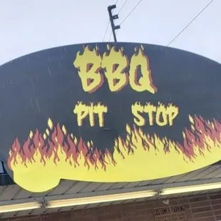 a bbq pit stop sign