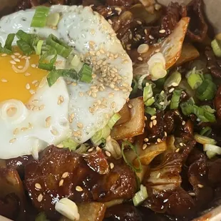 Spicy  chicken with an egg over rice