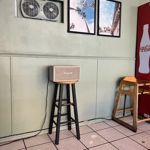 a coke machine and a stool