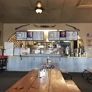 Inside with view of menu. Picnic table seating and regular table seating available.