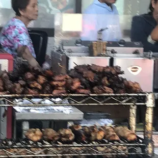 people standing in front of a bbq