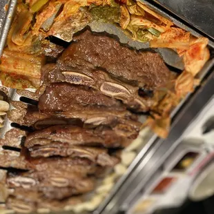 a tray full of meat and vegetables