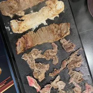 Marinated Beef Ribs, Garlic Pork Belly, Bulgogi, and Prime Brisket.