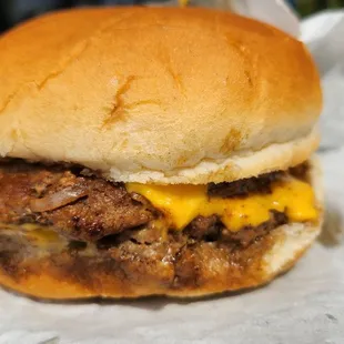 Delicious double cheeseburger with extra cheese request.