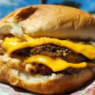 Delicious double cheeseburger with extra cheese request.