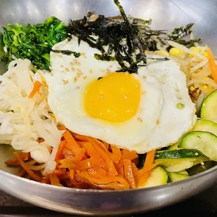 a bowl of vegetables and a fried egg